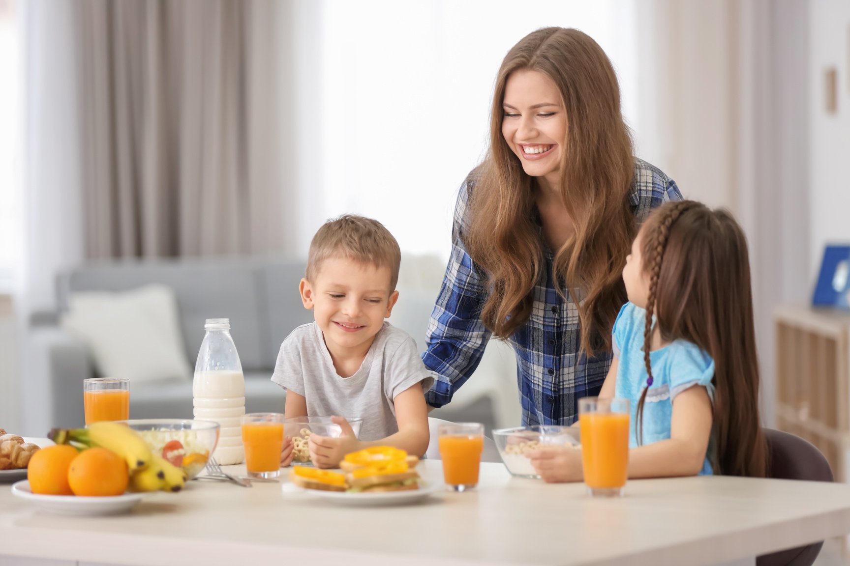 A Mother Serving Food to Children